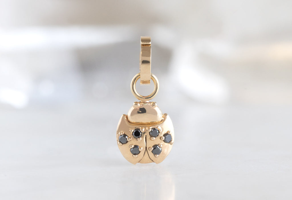 10k Yellow Gold Ladybug Charm on White Marble Tile