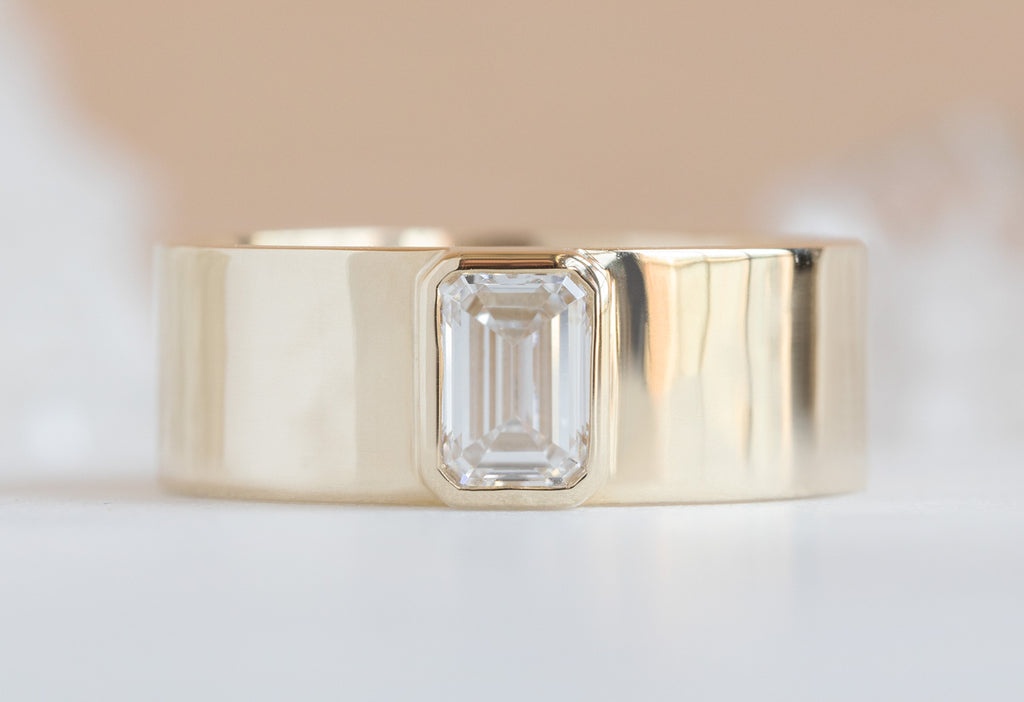 .65ct Emerald-Cut Lab Grown Diamond Cigar Band on Orange Background