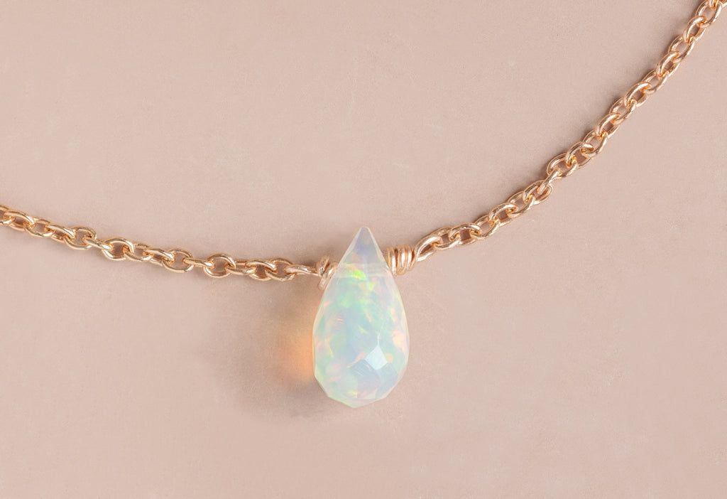 Close Up of Natural Opal Teardrop Bracelet in Rose Gold on Pink Background