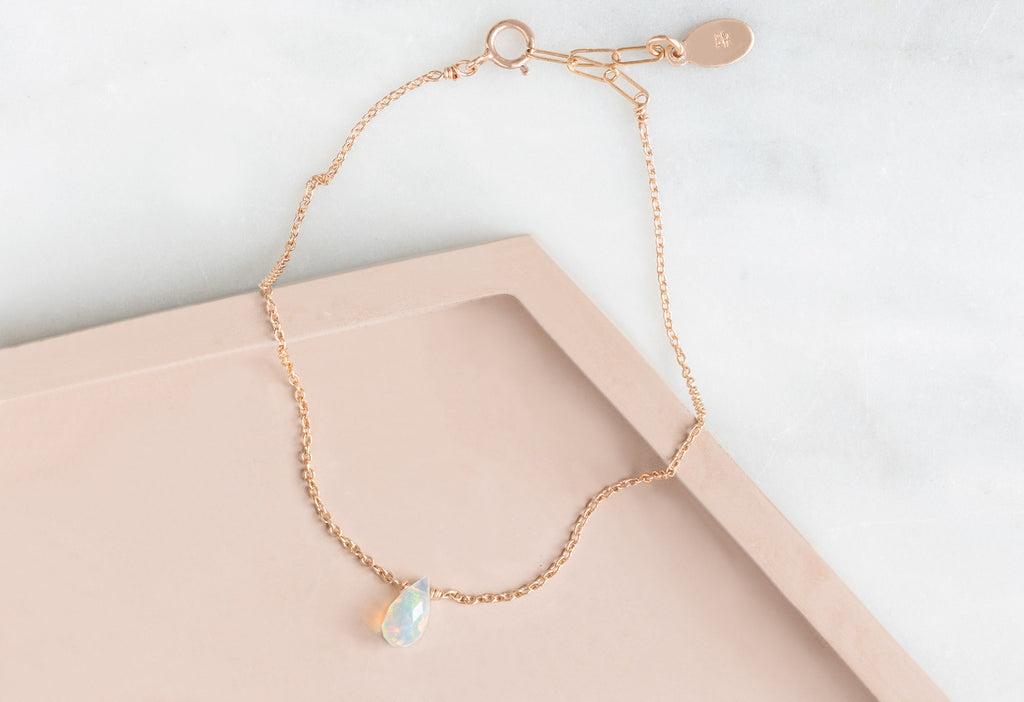 Natural Opal Teardrop Bracelet in Rose Gold on Pink Tile