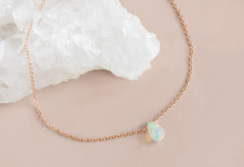 Natural Opal Teardrop Bracelet on Pink Background with White Crystal