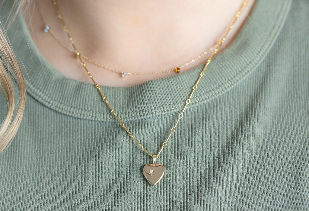 Yellow Gold Sweetheart Diamond Locket Necklace Layered on Model Wearing Green Ribbed Tank