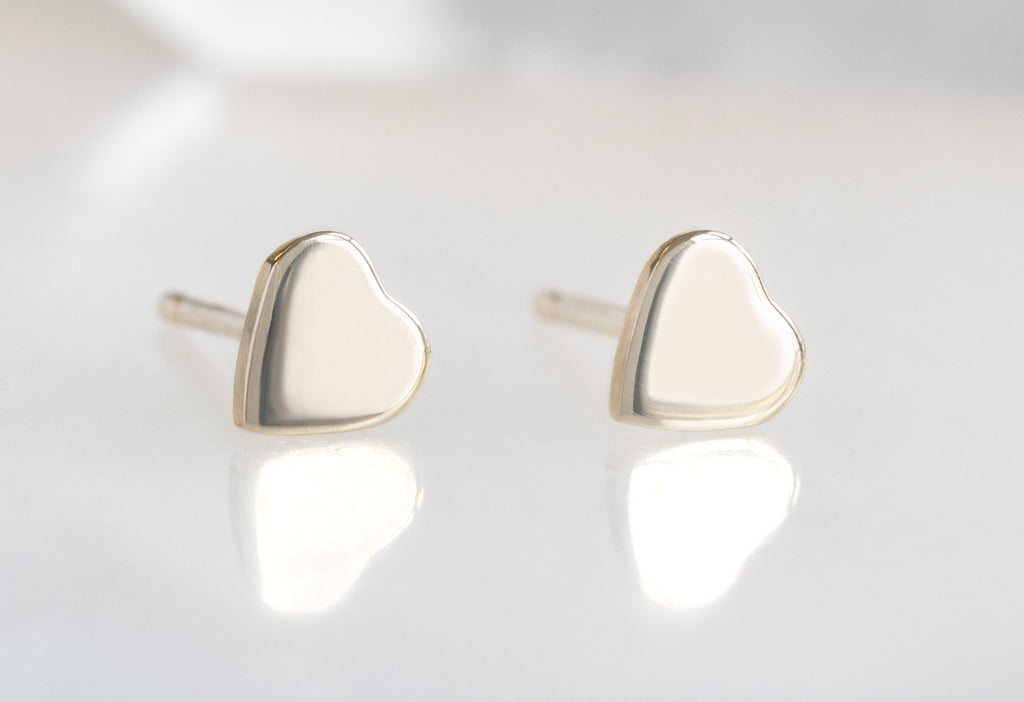 10k Yellow Gold Sweetheart Stud Earrings on  White Marble Tile