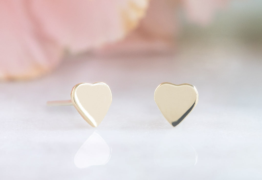 10k Yellow Gold Sweetheart Stud Earrings on White Marble Tile