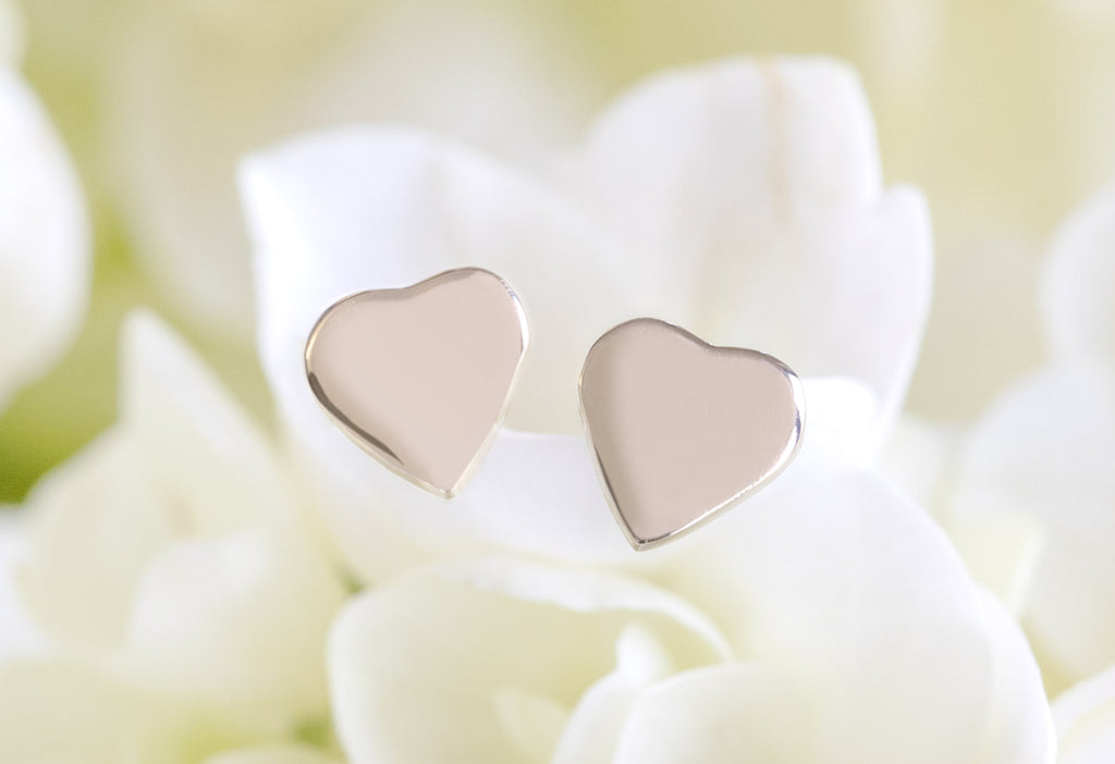 10k Yellow Gold Sweetheart Stud Earrings on White Flower Petals