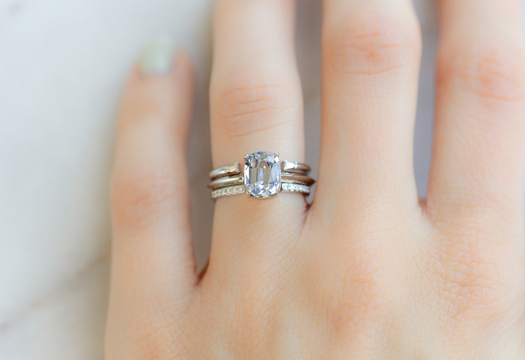 The Bryn Ring with a Cushion-Cut Tanzanite with White Diamond Stacking Bands on Model