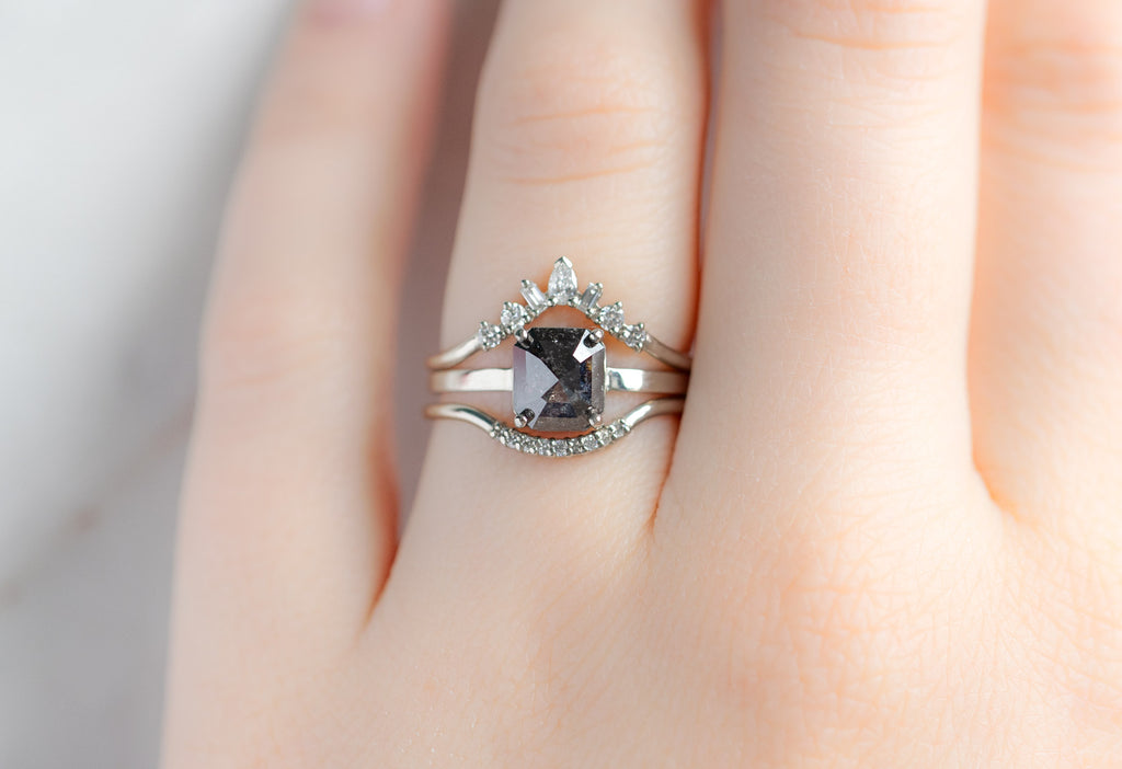 The Bryn Ring with an Emerald-Cut Black Diamond with White Diamond Stacking Bands on Model