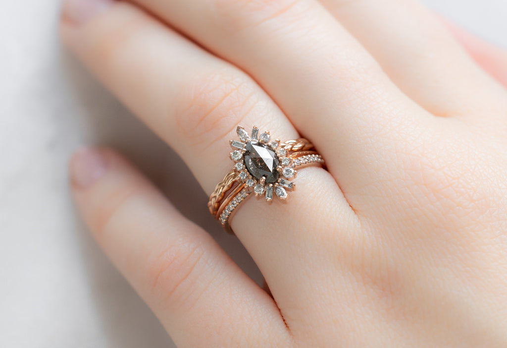 The Camellia Ring with a Black Marquise Diamond with Stacking Bands on Model