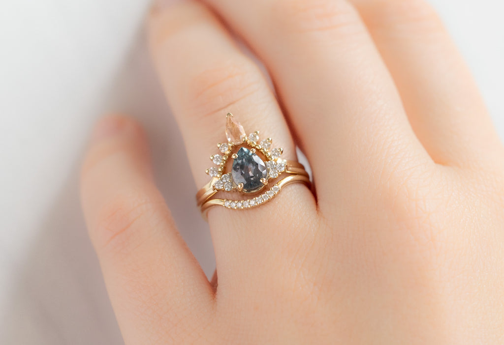 The Ivy Ring with a Pear-Cut Montana Sapphire with Stacking Bands on Model