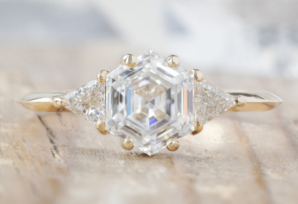 The Jade Ring with a Lab Grown Hexagon Diamond on Wood Table