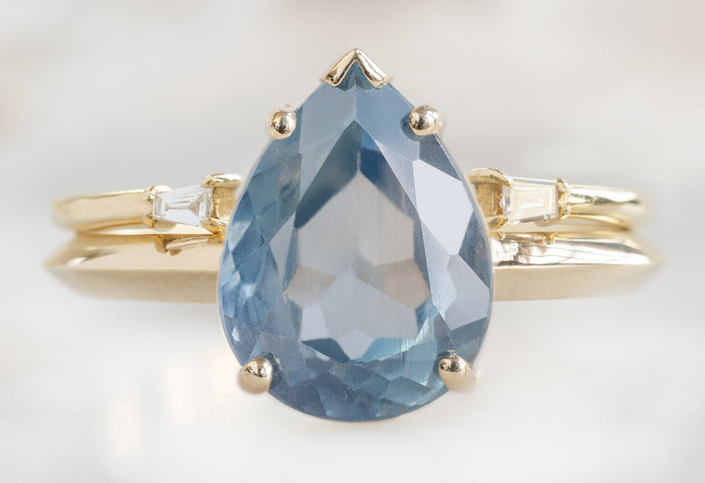 The Sage Ring with a Pear-Cut Montana Sapphire with Open Cuff Baguette Stacking Band