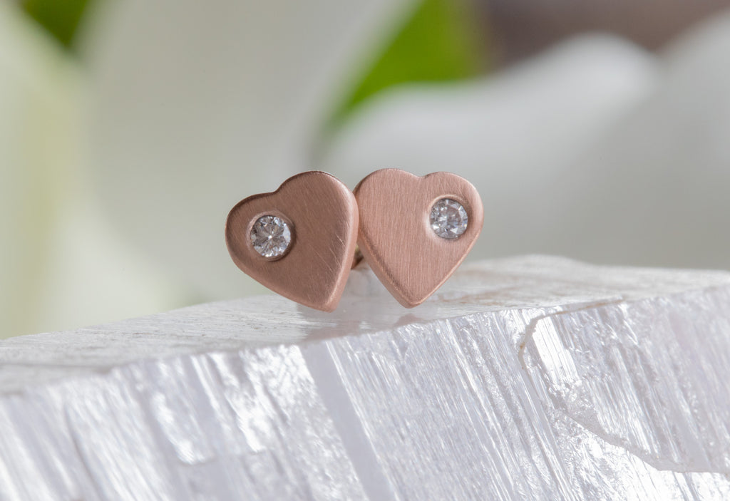 rose gold sweetheart diamond stud earrings on white crystal