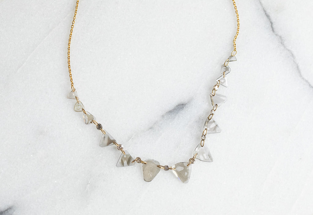 Yellow Gold Diamond Slice Pennant Necklace on White Marble Tile