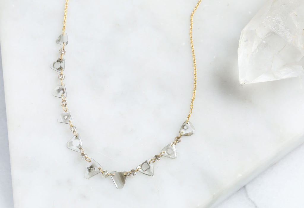 Yellow Gold Diamond Slice Pennant Necklace on White Marble Tile