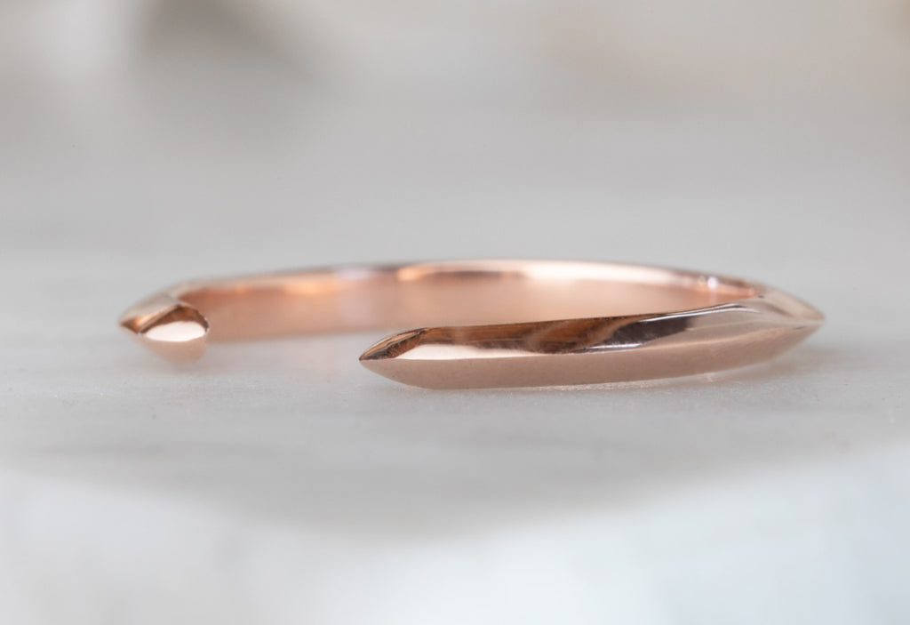 Rose Gold Open Cuff Knife Edge Wedding Band on White Marble Tile