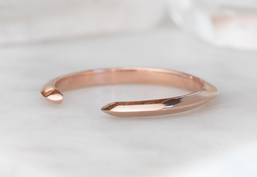 Rose Gold Open Cuff Knife Edge Wedding Band on White Marble Tile