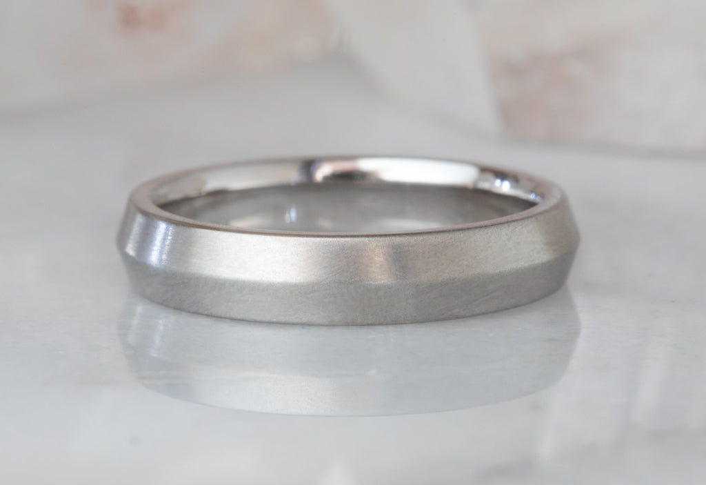 White Gold The Knife Edge Wedding Band on white marble tile