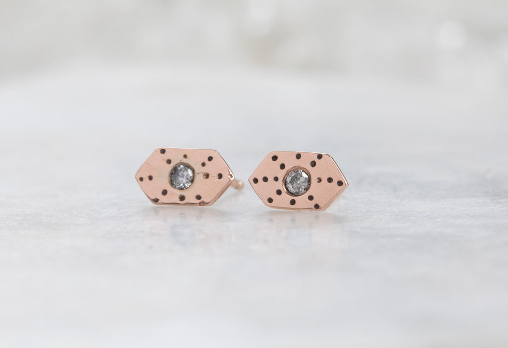 rose gold Hexagon Stardust Stud Earrings on white marble tile