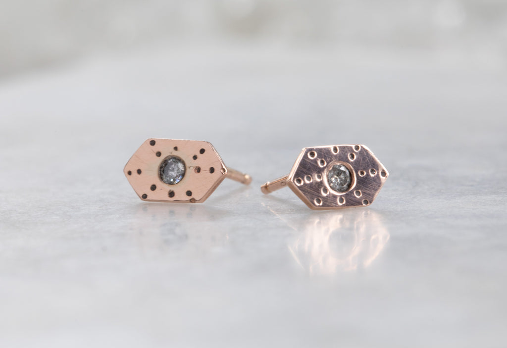 rose gold Hexagon Stardust Stud Earrings on white marble tile