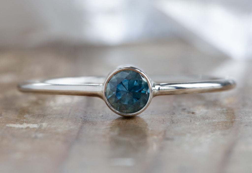 white gold Round Cut Montana Sapphire Stacking Ring on wood table