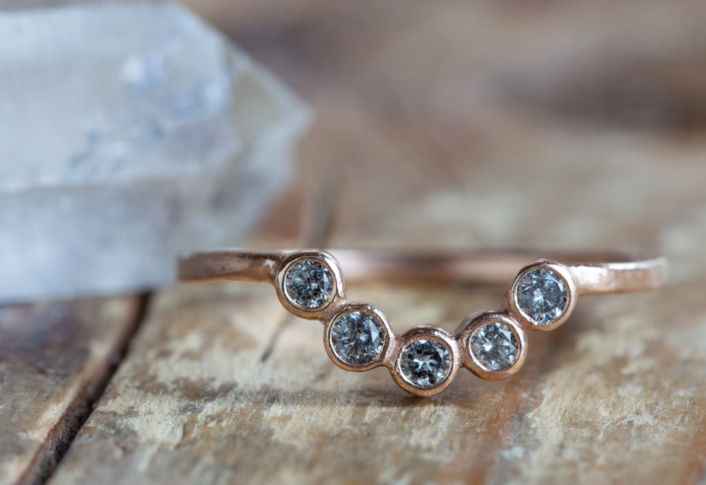 Rose Gold Diamond Bezel Arc Ring on Wood Table