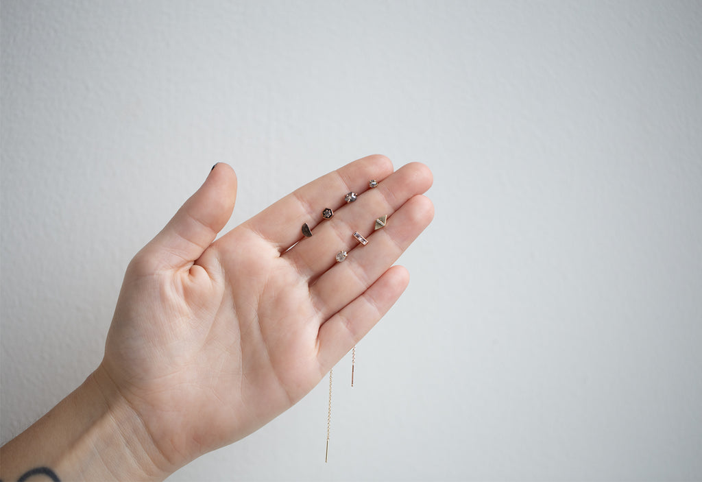 model holding stud earrings from Alexis Russell