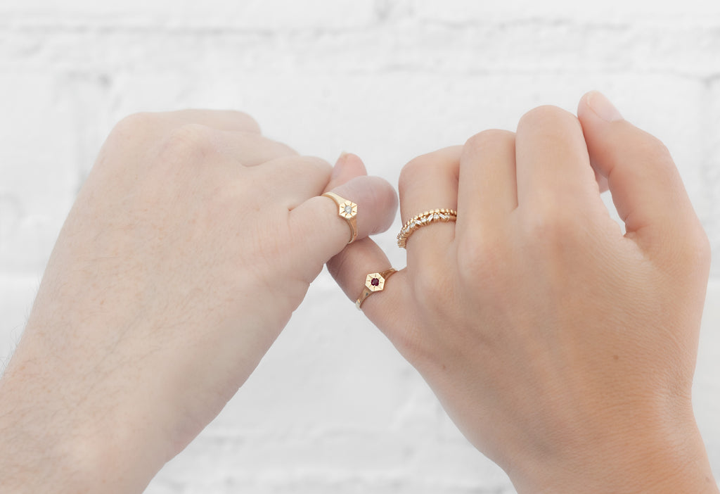 Models pinky promising while wearing Birthstone Signet Rings