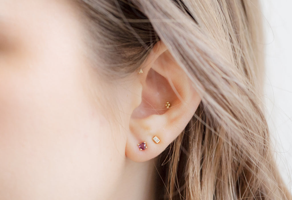 14k Yellow Gold Teensy Ruby Heart Studs on Model