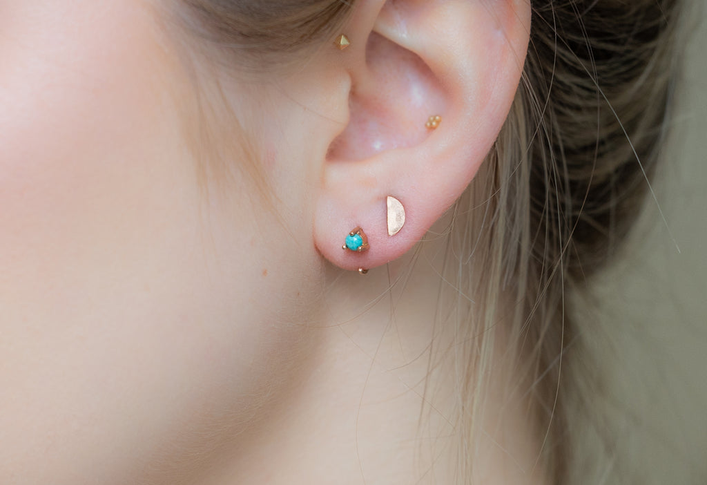 Turquoise Huggie Earrings Stacked on Model